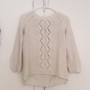 White sweater with button detail down the back